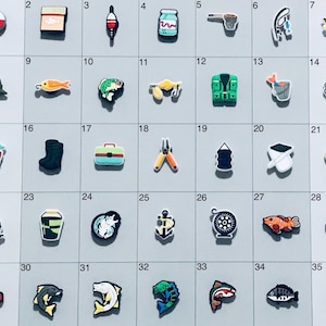 May include: A set of 35 colorful fishing-themed charms, including fish, lures, tackle boxes, and a life vest. The charms are arranged in a grid on a white background.
