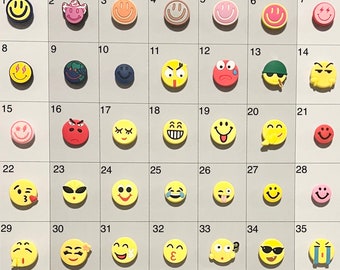 May include: A set of 35 yellow smiley face emoji charms with different expressions. The charms are arranged in rows and numbered 1 through 35.