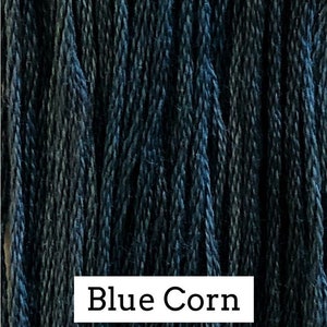 May include: A close-up of a bundle of blue yarn, with the text "Blue Corn" printed below.