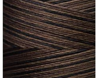 May include: Close-up of a spool of brown and black embroidery floss.