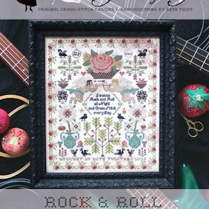 May include: A cross-stitch sampler with a black frame, featuring a floral design with a rose, birds, and the text "I wanna Rock and Roll all night and Grass Stitch every Day." The sampler is titled "Rock & Roll Sampler" and is signed "Wrought by Beth Twist AD 2023".
