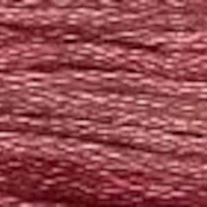 May include: Close-up of a spool of embroidery floss in a deep rose color. The thread is tightly wound, showing a textured surface. This craft supply is ideal for embroidery, cross-stitch, and other needlework projects.