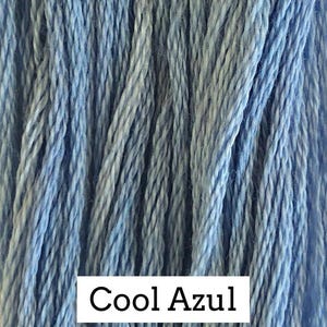 May include: A collection of light blue embroidery threads arranged in vertical strands, featuring a subtle variegated texture with lighter and darker blue tones. A white rectangular label at the bottom displays the text Cool Azul in black.