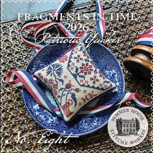 May include: A square cross-stitch pincushion featuring red and blue floral motifs on a cream fabric, accented with red, white, and blue striped ribbon. Text reads: FRAGMENTS IN TIME 2026 Patriotic Quaker No. Eight SUMMER HOUSE STITCH WORKES.