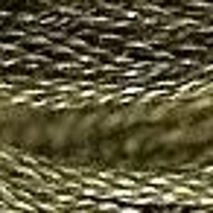 May include: Close-up of a skein of olive green embroidery floss. The floss is tightly wound, showing a twisted texture. A small red object is visible on the top left of the image.