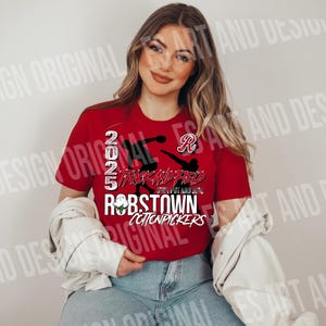 May include: Red, white, and black t-shirt with a graphic design of a person running with the text "2025 Track and Field Step Up and Dig Robstown Cottonpickers".