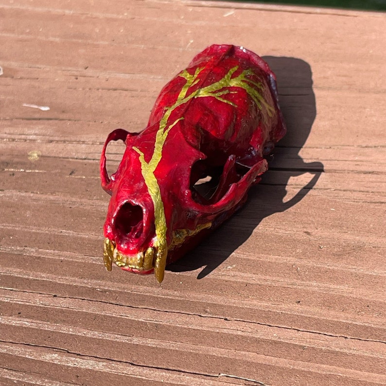 Real painted mink skull, red and gold lightning image 1