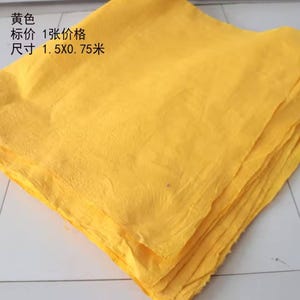 May include: A stack of bright yellow fabric, measuring 1.5 x 0.75 meters. The fabric is folded neatly and has a slightly textured surface.