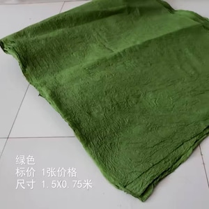 May include: A textured green fabric sheet. The text on the sheet reads: "绿色 标价 1 张 价格 尺寸 1.5x0.75 米".