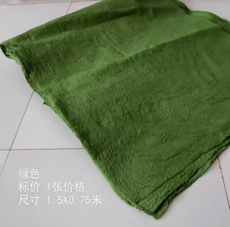 May include: A textured green fabric sheet. The text on the sheet reads: "绿色 标价 1 张 价格 尺寸 1.5x0.75 米".