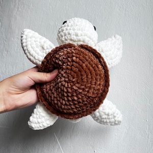 A plush turtle crocheted by handmade amigurumi