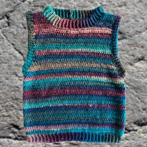 May include: A striped crocheted vest in a range of colours, including teal, purple and brown.