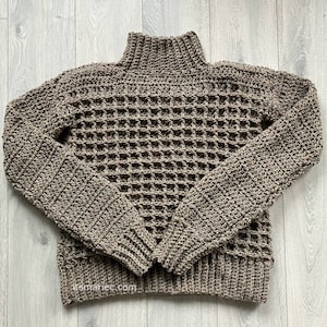 May include: A brown crocheted sweater with a high neck and a waffle stitch pattern.