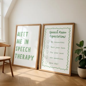 May include: Two framed posters with wooden frames. The left poster reads "MEET ME IN SPEECH THERAPY" in green text. The right poster says "Speech Room Expectations" with bullet points in green. A chair and plant are in the background.
