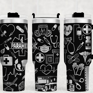 May include: Three stainless steel tumblers with black and silver designs. The tumblers feature a variety of medical symbols, including a stethoscope, a heart, a cross, and a bandage. The text "PARAMEDIC" is printed on one of the tumblers.
