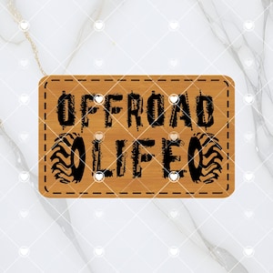 May include: A brown wooden sign with a stitched border. The sign has black text that reads "OFFROAD LIFE" with tire tread graphics on either side of the text.