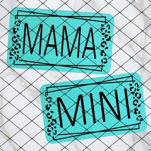May include: Two rectangular teal-colored designs with black text that reads "MAMA" and "MINI". Each design has a black border and leopard print accents. The background is a white tile pattern.