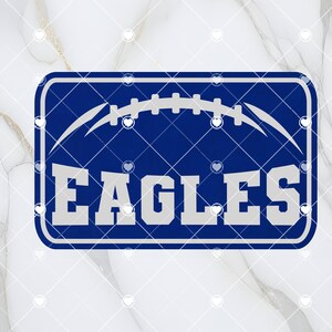 Puede incluir: Un letrero rectangular azul y blanco con un gráfico de fútbol y la palabra "EAGLES" en texto blanco.