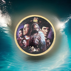 May include: A gold-colored round plate with a black background featuring a scene from Star Trek IV: The Voyage Home. The plate depicts the main characters from the film, including Captain Kirk, Spock, and Scotty, against a backdrop of stars and a futuristic cityscape. The text "STAR TREK IV" is printed in gold lettering around the edge of the plate.