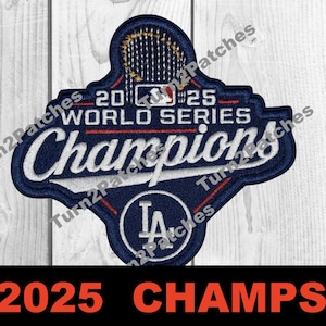 May include: A navy blue and white embroidered patch with the text "2025 World Series Champions". The patch features the Los Angeles Dodgers logo and the words "LA" inside a circle. The bottom of the image has the text "2025 CHAMPS!" in orange.