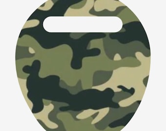 May include: A round, camouflage-patterned item with a handle. The design features a mix of green, brown, and tan shapes, creating a military-inspired aesthetic. The handle is a white, rectangular cutout at the top of the circle.