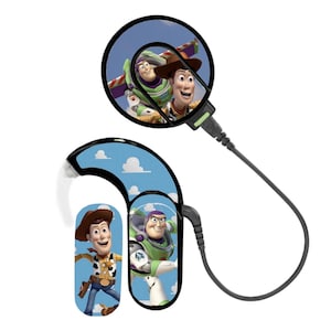May include: A hearing aid featuring images of Woody and Buzz Lightyear from the animated film Toy Story. The device has a blue sky and cloud design, with a black cable and a circular image of the characters.