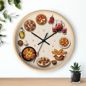 May include: A round wall clock with a light wood frame. The clock face features illustrations of Spanish cuisine, including paella, tapas, olives, and sangria. Black clock hands point to the time.
