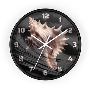 May include: Round wall clock with a black frame featuring a seashell design. The clock face has a black and white wave pattern with a seashell in the center. White hands and numerals complete the design.