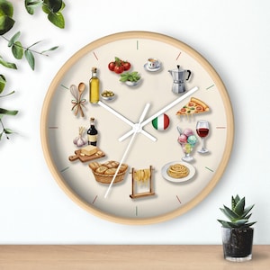 May include: A round wall clock with a light wood frame and a cream-colored face. The clock face features illustrations of Italian food items like pizza, pasta, and tomatoes. The Italian flag is also displayed on the clock face.
