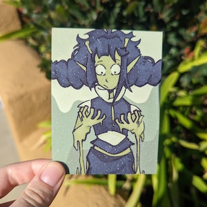 May include: A rectangular art print featuring a cartoon character with green skin, dark blue hair, and a worried expression. The character is wearing a dark blue outfit with a white collar. The background is a light green with a glittery effect.