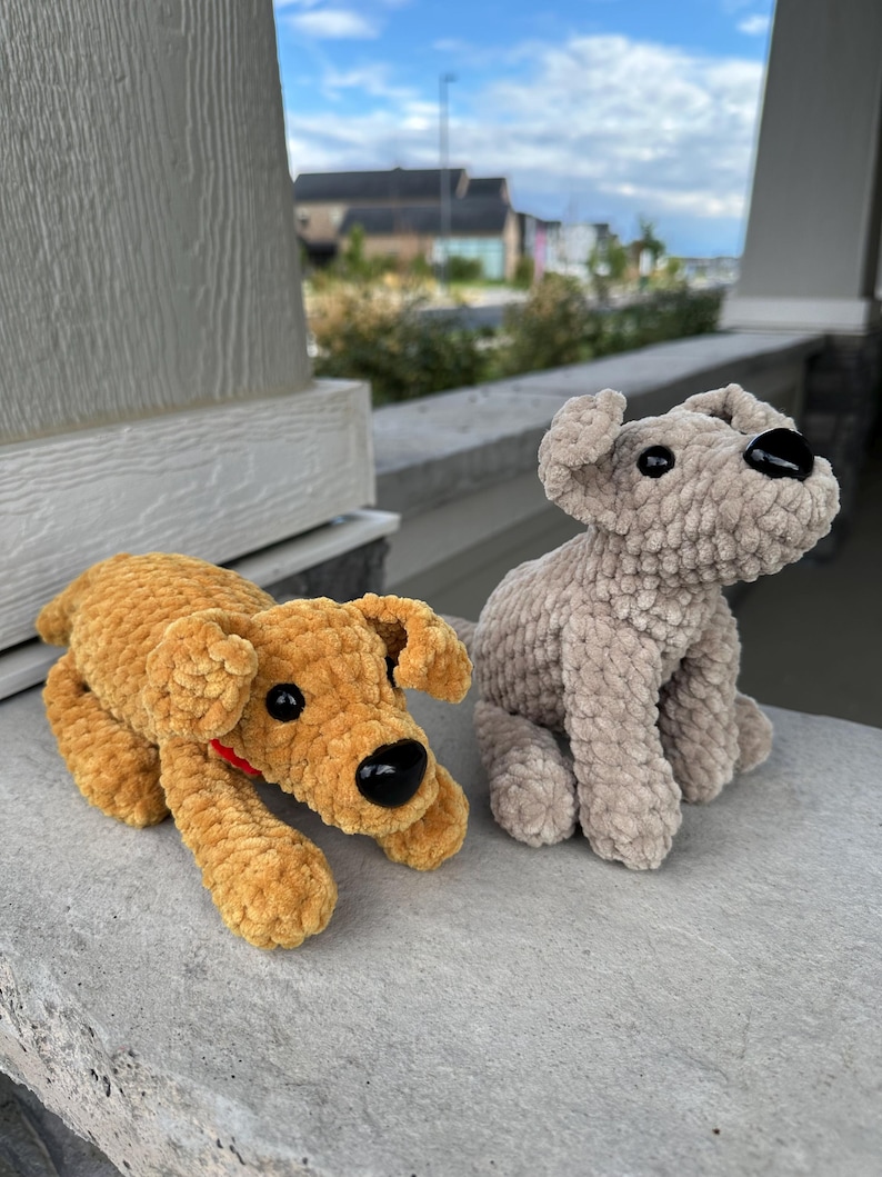 May include: Two crocheted plush dog toys. One is brown and the other is gray. Both have black eyes and noses.