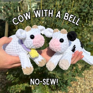 May include: Two crocheted cow plushies, one white with a purple and yellow ribbon, and the other white with black spots. The plushies are held in a hand and the text "COW WITH A BELL NO-SEW!" is below them.