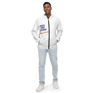 May include: White zippered jacket with a blue and orange graphic that says "HODL THE FUTURE" and "Stay Forever".