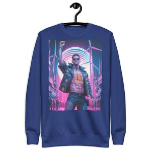 May include: A royal blue sweatshirt with a graphic print of a man in a leather jacket with a bitcoin symbol on his chest. The background is a neon pink and blue cityscape with wind turbines.