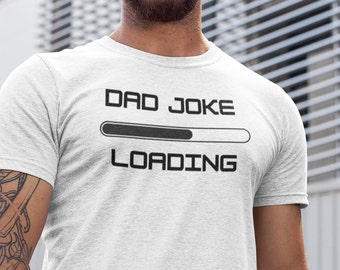 May include: A white t-shirt with the text "DAD JOKE LOADING" and a progress bar graphic.