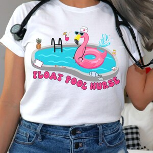 May include: White t-shirt featuring a pink flamingo pool float, a blue swimming pool, and the text "Float Pool Nurse".