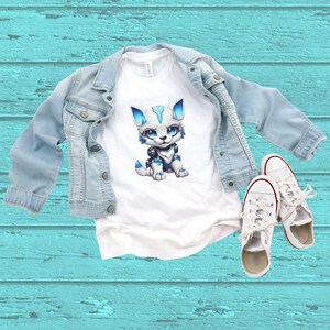 May include: White t-shirt with a blue and white cartoon robot wolf graphic.
