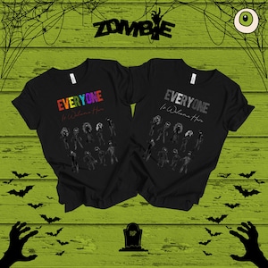 「Everyone Is Welcome Here」Tシャツ、不気味なゾンビグラフィックTシャツ、不気味な季節やゾンビパーティーのアパレルにぴったりのハロウィンホラーシャツ、アンデッドシャツ