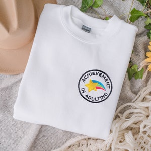 Achievement in Adulting Merit Badge Embroidered Unisex Crewneck Sweatshirt | Millennial Sweatshirt | Adulting Sweater | Funny College Tee