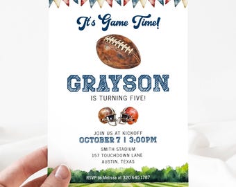 May include: A football-themed birthday invitation for a boy named Grayson turning five. The invitation features a watercolor illustration of a football field, a football, and two football helmets. The text on the invitation reads "It's Game Time! Grayson is turning five! Join us at kickoff October 7 | 3:00PM Smith Stadium 157 Touchdown Lane Austin, Texas RSVP to Melissa at 320.645.1787"