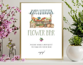 May include: A framed print with a watercolour illustration of a flower bar. The image features a market stall with produce and the text "FLOWER BAR". The sign also includes the text "PLEASE MAKE A BOUQUET TO TAKE ON YOUR WAY" and "enjoy!"