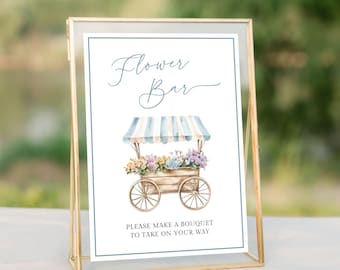 May include: A white sign with blue text that reads "Flower Bar" and a watercolour illustration of a flower cart with a striped awning. The sign also says "Please make a bouquet to take on your way."