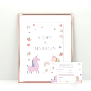May include: A framed print with a rose gold border featuring the text "ADOPT A UNICORN". The image includes illustrations of unicorns, rainbows, hearts, and crowns. A matching adoption certificate is also included.