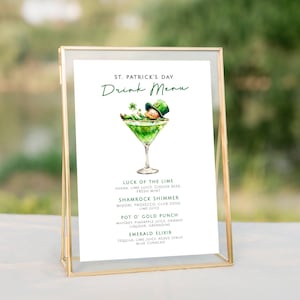May include: A printable St. Patrick's Day drink menu with a cartoon illustration of a leprechaun in a green hat and green suit relaxing in a martini glass. The menu lists four drink options: Luck of the Lime, Shamrock Shimmer, Pot O' Gold Punch, and Emerald Elixir.