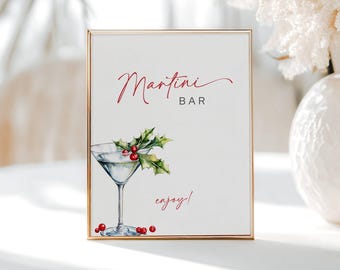 May include: A framed sign with a gold border features the words "Martini Bar" in red script. A watercolor illustration of a martini glass with holly and berries is below the text, with the word "enjoy!" in red script.