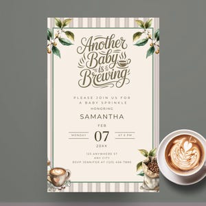 May include: A baby shower invitation with the text "Another Baby is Brewing" in elegant script. The invitation features floral accents, a coffee cup graphic, and a cup of latte art. The invitation is for Samantha on February 7th.