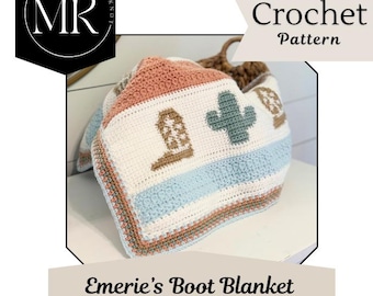 May include: A crochet blanket featuring a western-themed pattern with motifs of brown cowboy boots and green cacti on a white background. The blanket has horizontal stripes in light blue and terracotta, with a textured border in matching colors.
