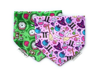 May include: Two dog bandanas with Halloween themes. One bandana is green with a zombie face pattern and the other is pink with a witch and potion pattern. Both bandanas have the text "pa's'paya" on the bottom.