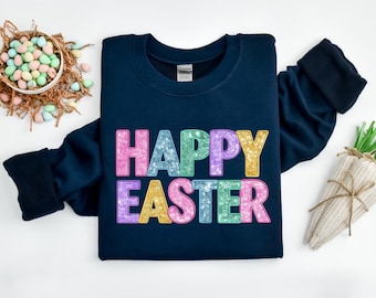 May include: A navy blue sweatshirt with the text "HAPPY EASTER" in colorful glitter letters.