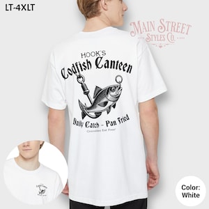 May include: White t-shirt with a black and white graphic of a fish on a hook, with the text "HOOK'S Codfish Canteen" above and "Daily Catch - Pan Fried" below. The shirt is labeled "LT-4XLT".